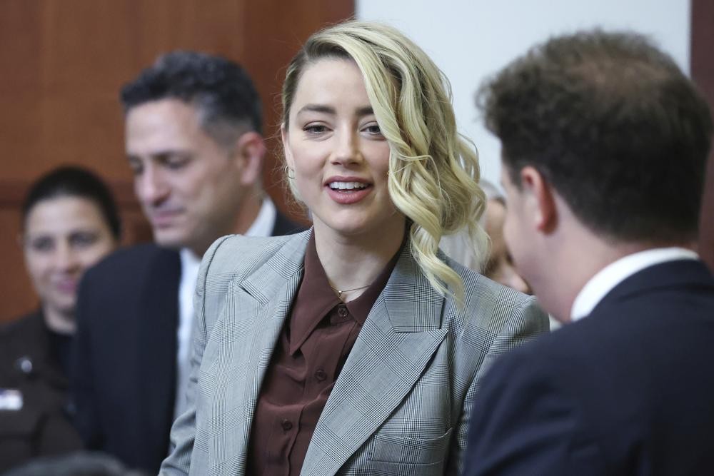 Actor Amber Heard arrives in the courtroom in the Fairfax County Circuit Courthouse in Fairfax, Va., Thursday, May 26, 2022. Actor Johnny Depp sued his ex-wife Amber Heard for libel in Fairfax County Circuit Court after she wrote an op-ed piece in The Washington Post in 2018 referring to herself as a "public figure representing domestic abuse." (Michael Reynolds/Pool Photo via AP)